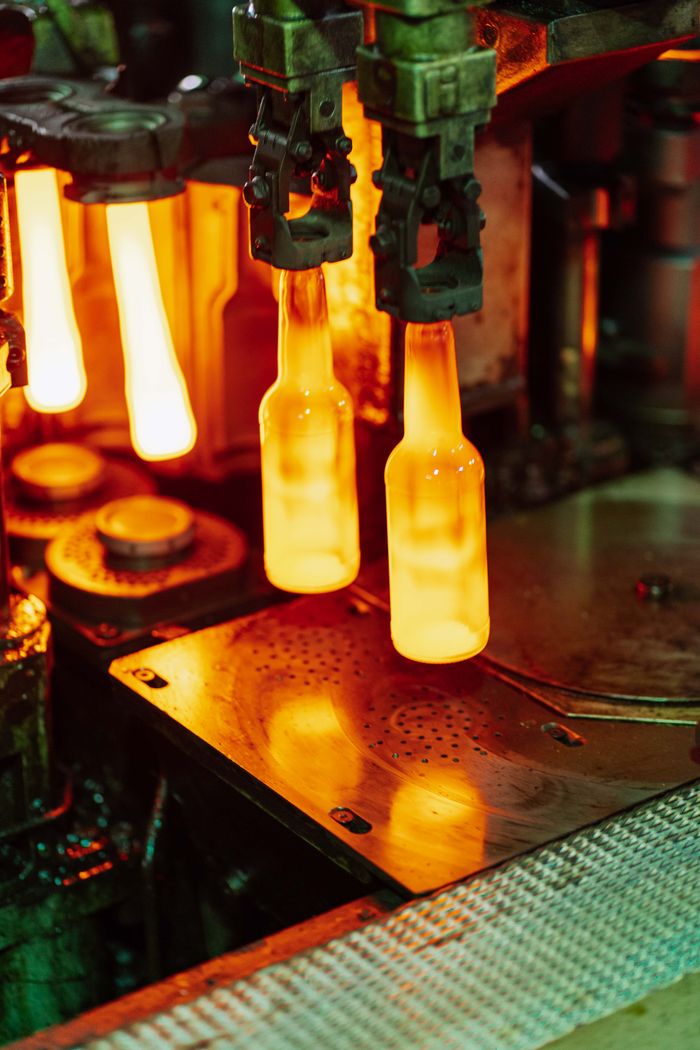 Close-up of glass bottles in a manufacturing process at a factory in Dar es Salaam, Tanzania.