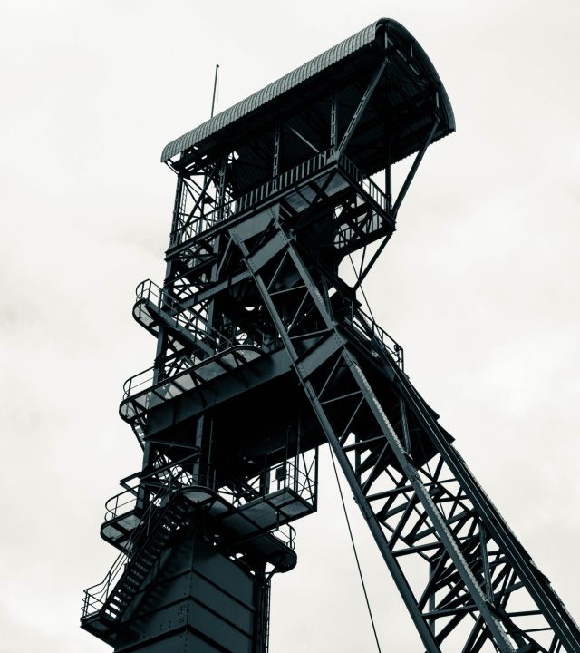 Dramatic view of a towering industrial framework against a cloudy backdrop in Hückelhoven, Germany.